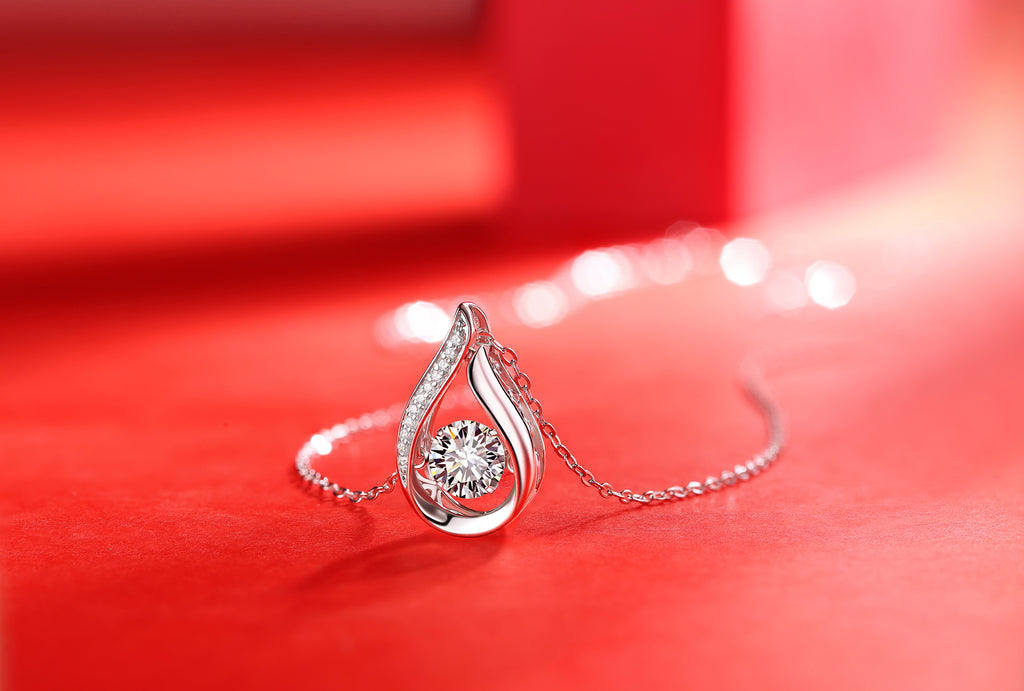 Teardrop moissanite pendant with pavé frame, close-up