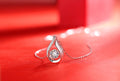 Teardrop moissanite pendant with pavé frame, close-up