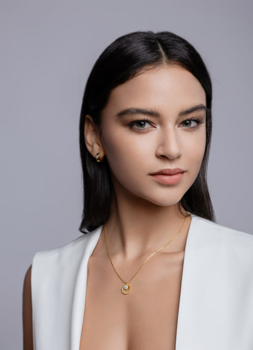 Model wearing the gold beaded halo moissanite pendant
