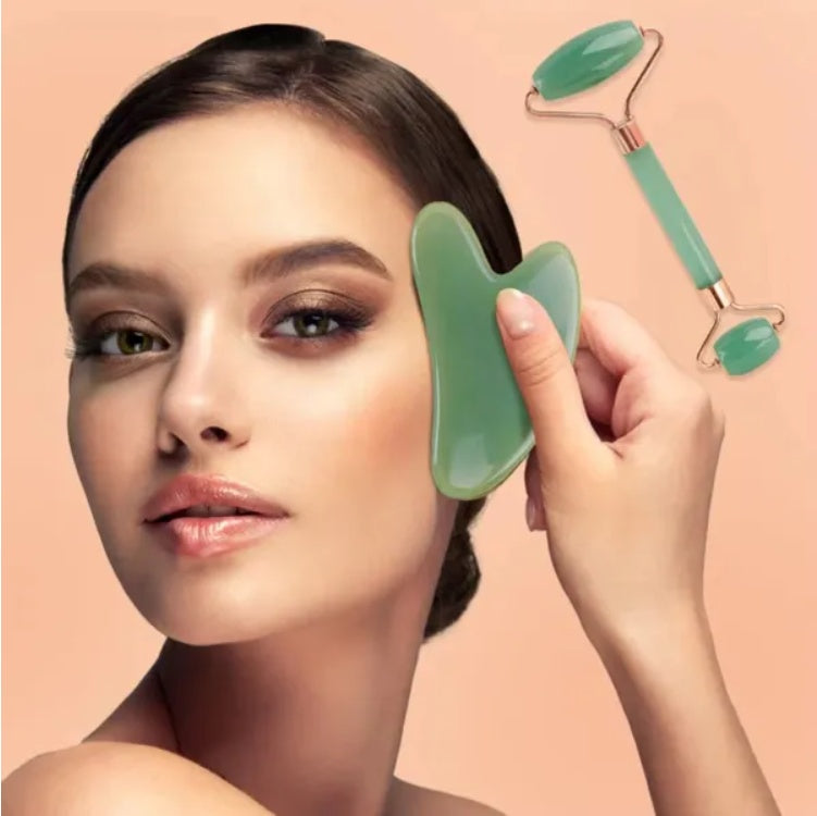 Woman using the green gua sha board and face roller