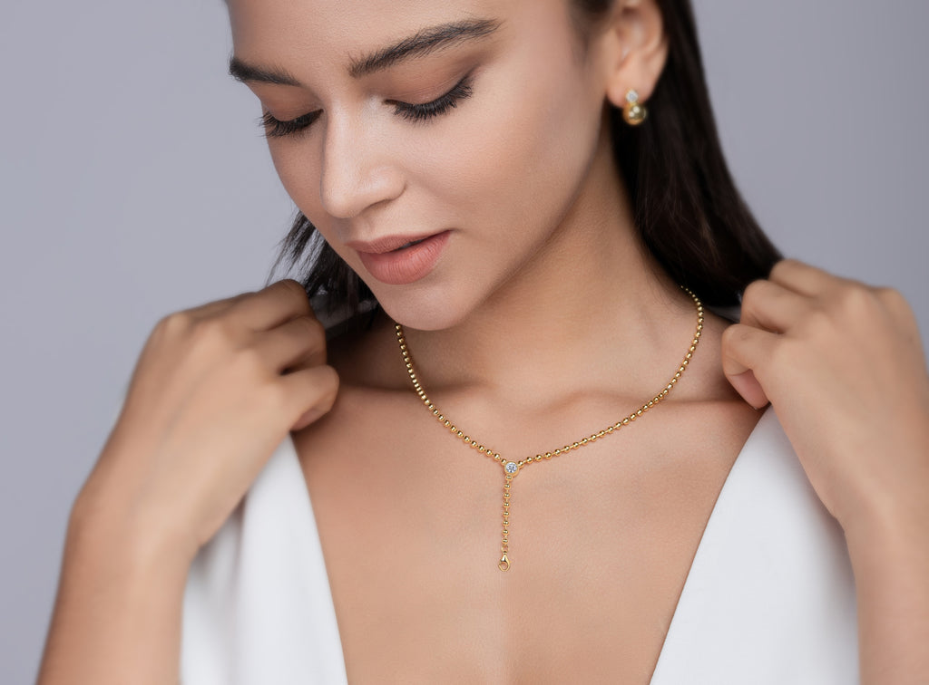 Model wearing the gold lariat Y necklace