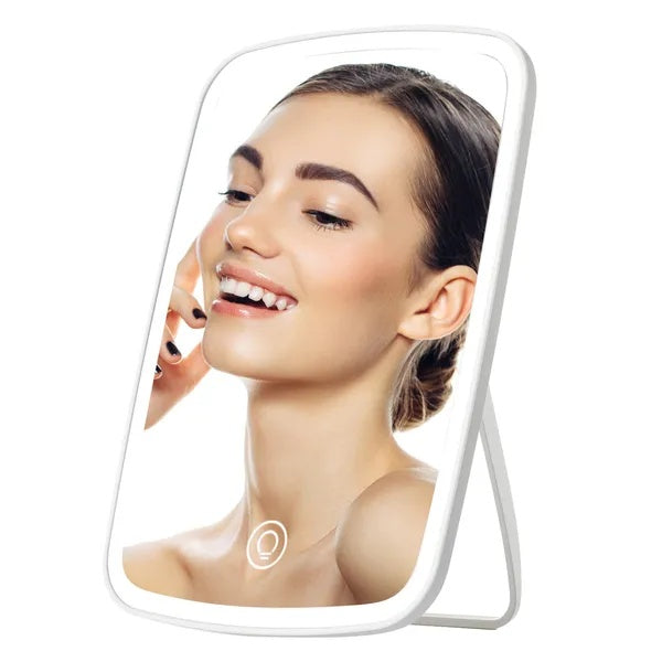 Woman's reflection in the compact LED makeup mirror