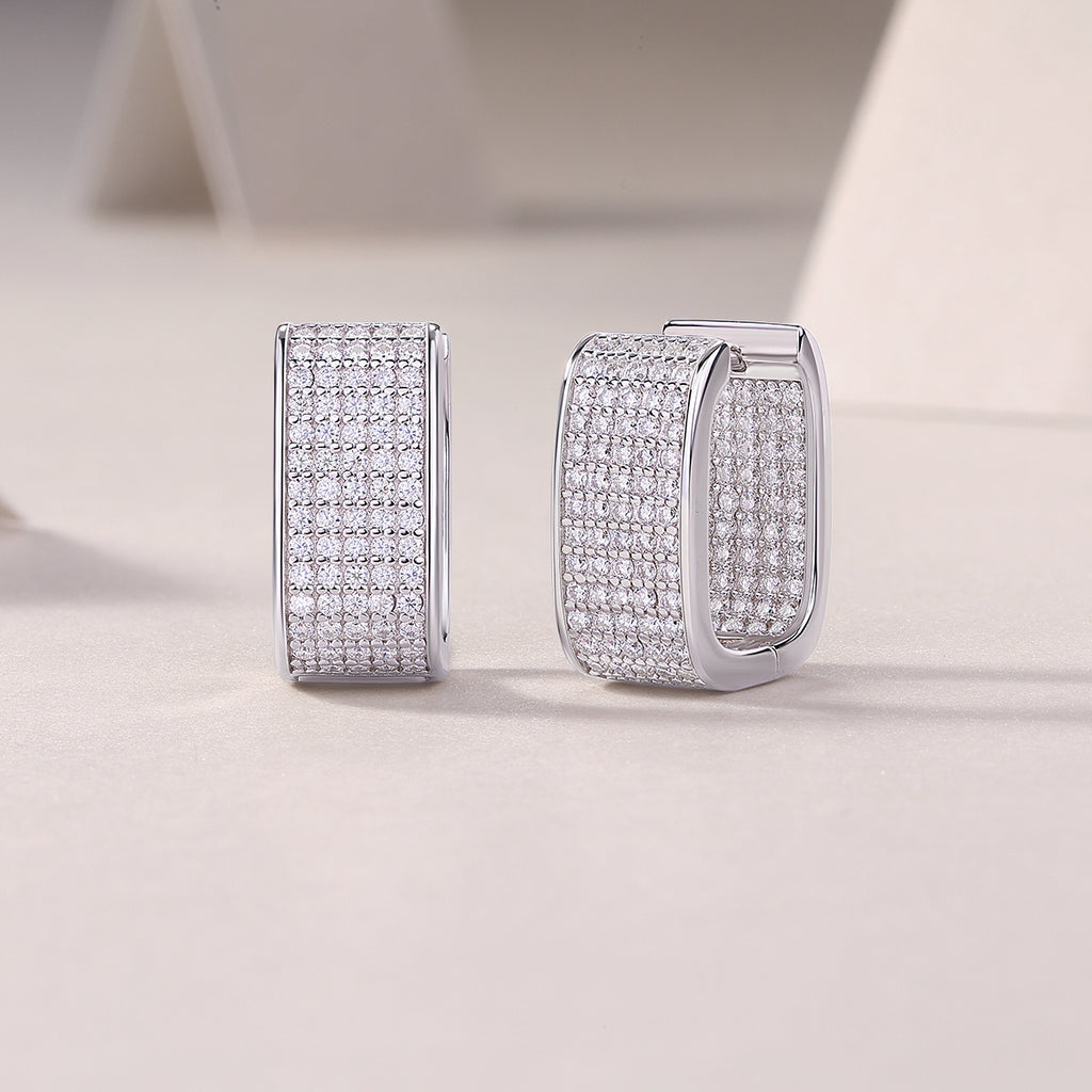 Wide pavé moissanite huggie earring, close-up