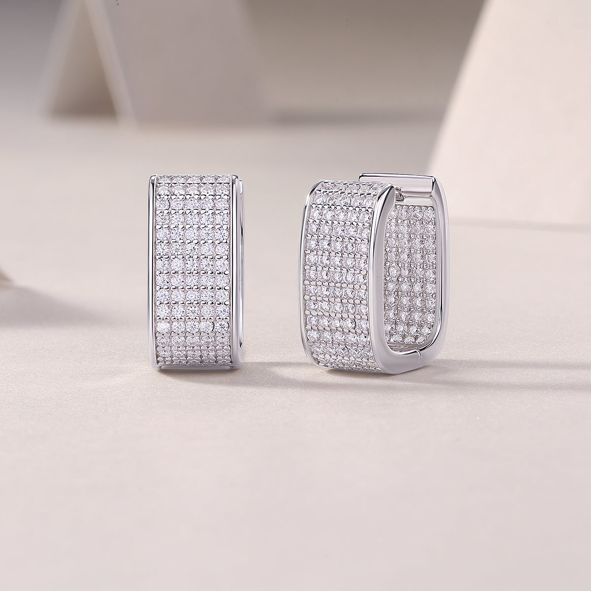 Wide pavé moissanite huggie earring, close-up