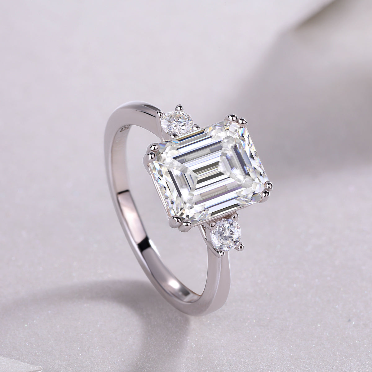 Emerald-cut moissanite three-stone ring in 925 sterling silver