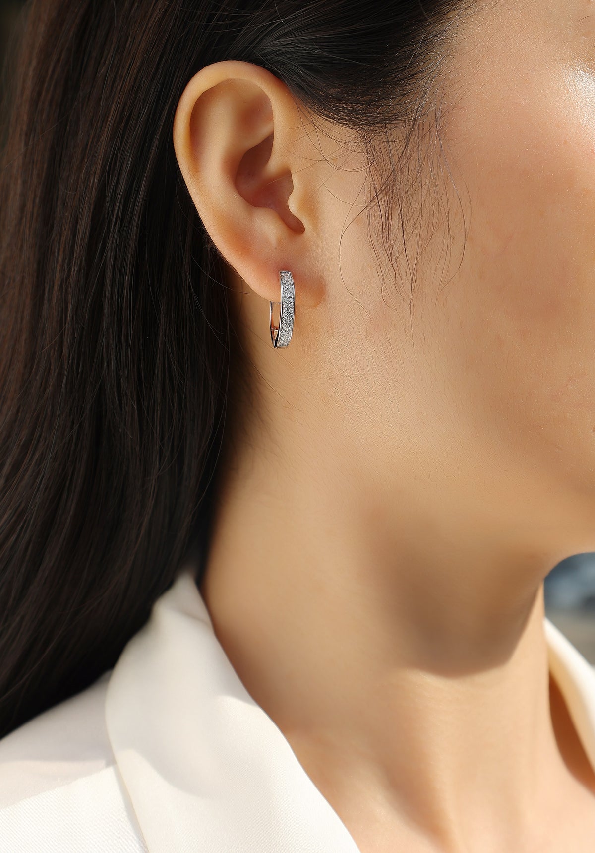 Double-row pavé hoop earring worn, close-up