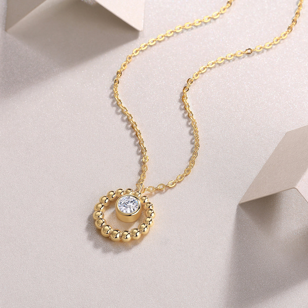 Gold beaded halo pendant with a 0.5 ct moissanite on a fine chain