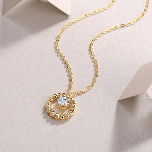 Gold beaded halo pendant with a 0.5 ct moissanite on a fine chain