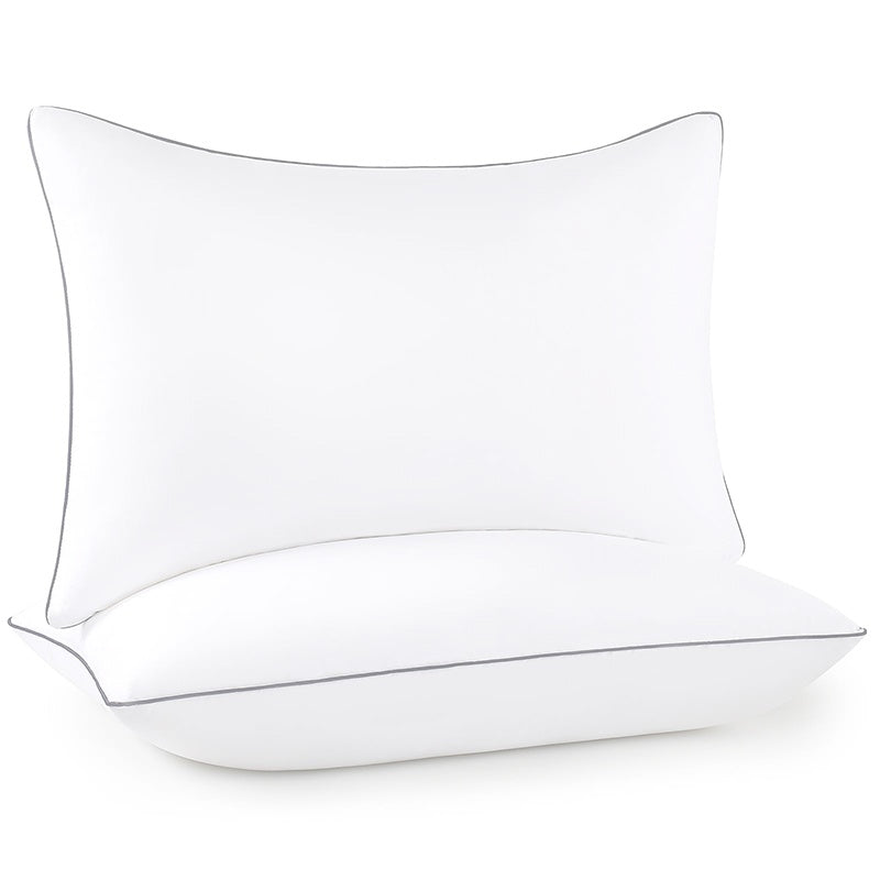 Hotel collection pillows on a made bed